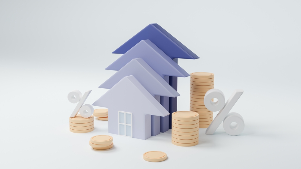 Wooden models of houses, coins and percentage symbols